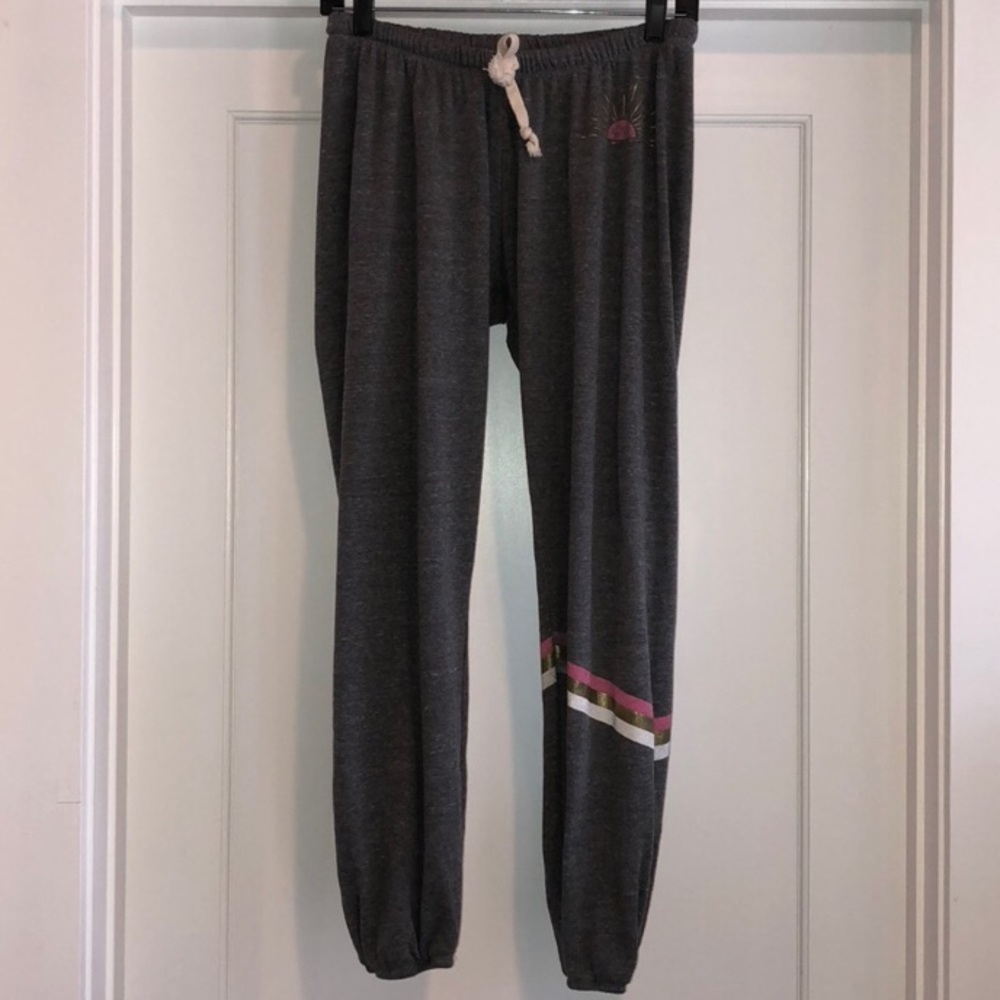 Grey sweat pants with pink, white, + gold stripes